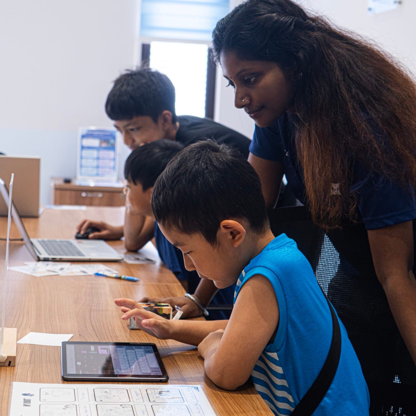 Students at KURAI working on AI projects